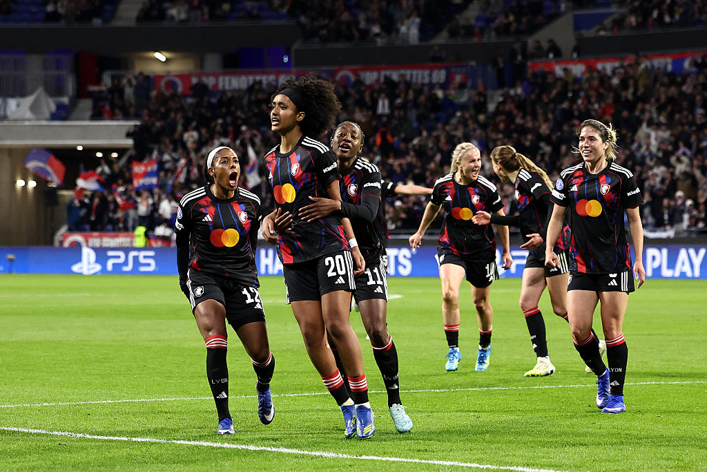 UWCL semifinals star Lily Yohannes of OL Lyonnes celebrates scoring her team's first goal with teammates Ashley Lawrence and Kadidiatou Diani during the UEFA Women's Champions League 2025/26 Quarter-finals Second Leg match between OL Lyonnes and VfL Wolfsburg at OL Stadium on April 02, 2026 in Decines-Charpieu, France.