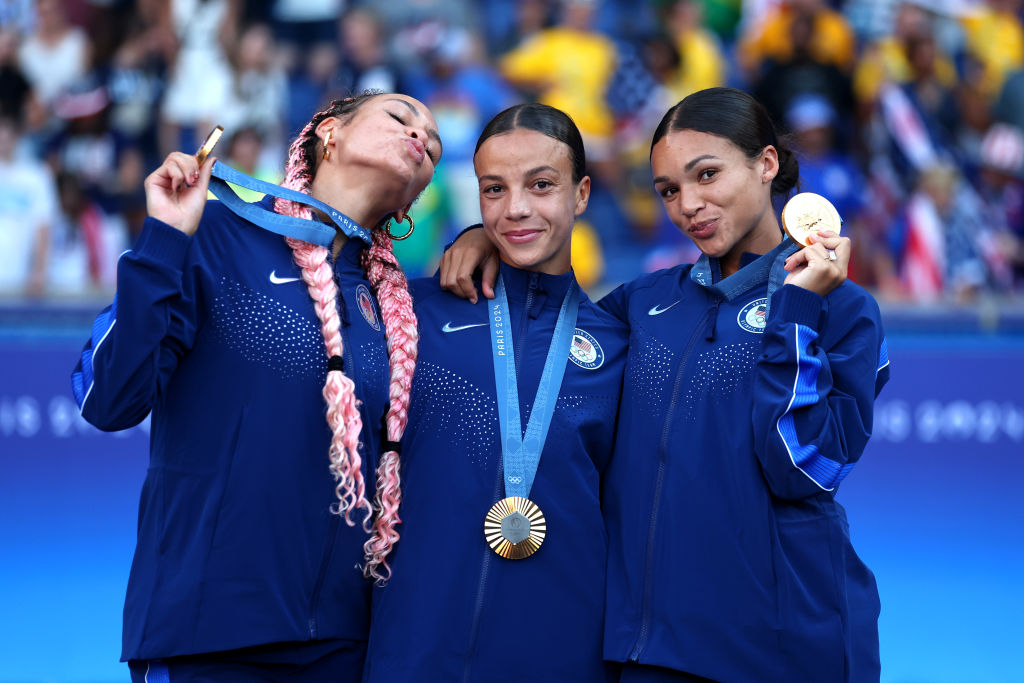 USWNT Triple Espresso Gold Medalists Trinity Rodman #5, Mallory Swanson #9, Sophia Smith #11 of the USWNT roster pose for a photo with the medals after the Women's Football medal ceremony following the Women's Gold Medal match between Brazil and United States of America during the Olympic Games Paris 2024 at Parc des Princes on August 10, 2024 in Paris, France.