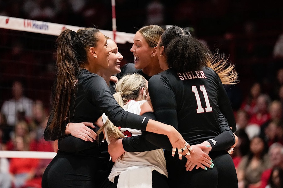 Spikes Under the Lights NCAA volleyball team Nebraska volleyball teammates, from left, Harper Murray #27, Bergen Reilly #2, Andi Jackson #15, Teraya Sigler #11 and Laney Choboy #6 embrace as they win against the Wisconsin Badgers in three straight sets at Wisconsin Field House on October 31, 2025 in Madison, Wisconsin.