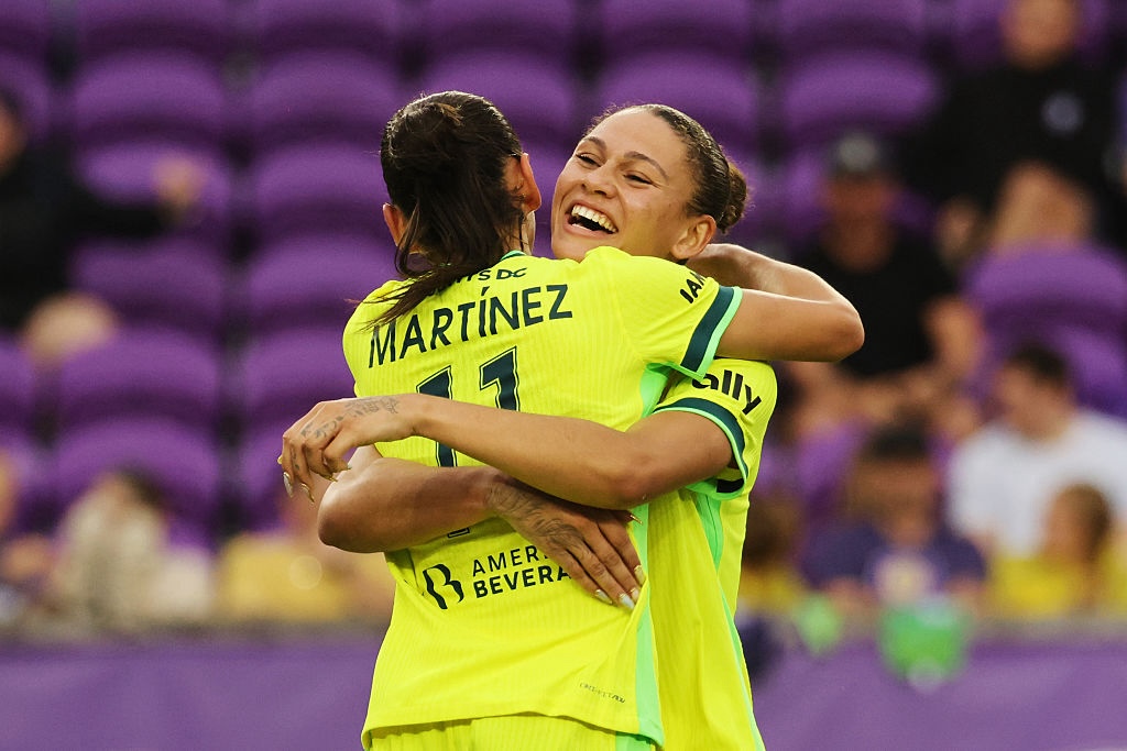 Claudia Martinez #11 of Washington Spirit celebrates scoring her team's third goal with teammate Trinity Rodman #2 during the NWSL match between Orlando Pride and Washington Spirit at Inter&Co Stadium on May 02, 2026 in Orlando, Florida.