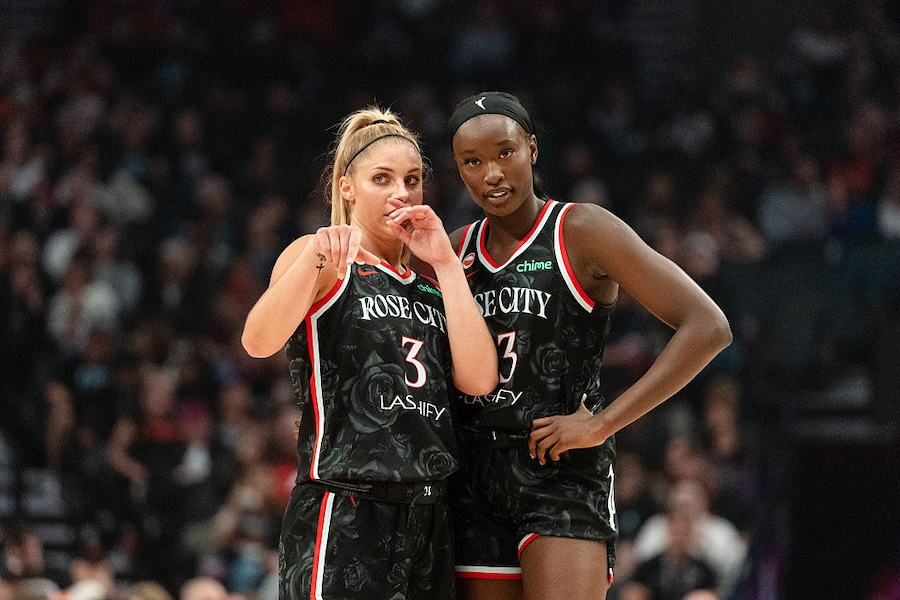 Sarah Ashlee Barker #3 and Nyadiew Puoch #13 of the Portland Fire talk over a play during a free throw in the first half go the game against the New York Liberty at Moda Center on May 14, 2026 in Portland, Oregon.