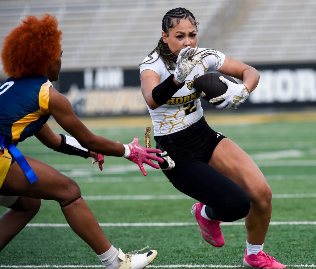 Alabama State's Jasmine Dunn (2) carries against Andrew College during their flag football game on the ASU campus in Montgomery, Ala.