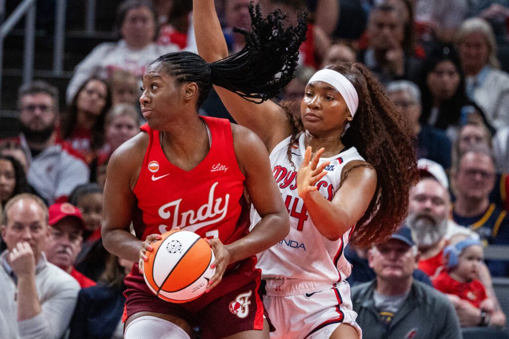 Indiana Fever center-forward Aliyah Boston (7) shoots the ball while Washington Mystics forward Kiki Iriafen (44) defends in the first half at Gainbridge Fieldhouse.