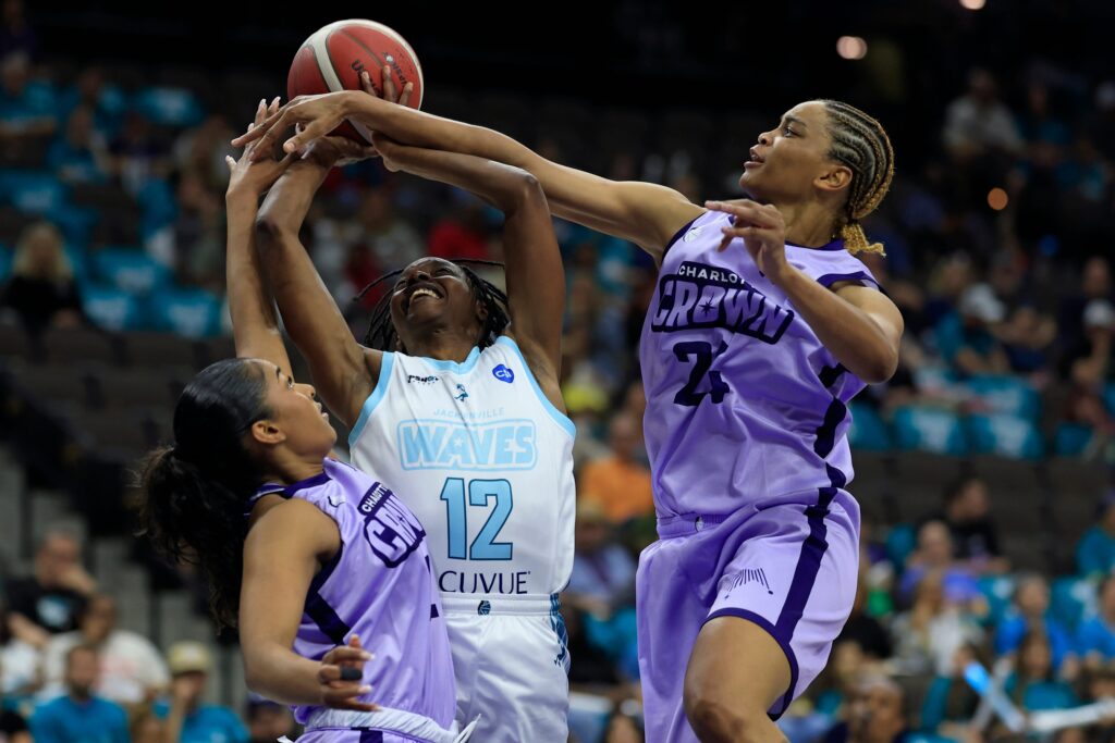 Jacksonville Waves guard Ariel Hearn (12) is guarded by Charlotte Crown guard Deja Kelly (2) and forward Lele Grissett (24) during the third quarter of an UpShot League pro women’s basketball game at VyStar Veterans Memorial Arena, Friday, May 15, 2026.