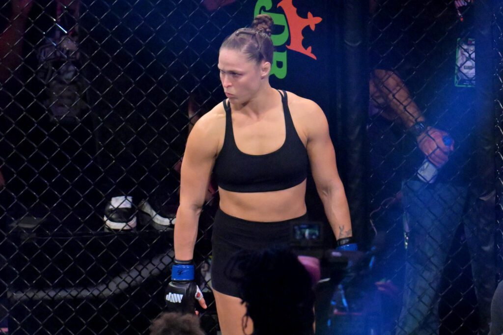 Ronda Rousey looks on before fighting Gina Carano in a women's featherweight bout at Intuit Dome.