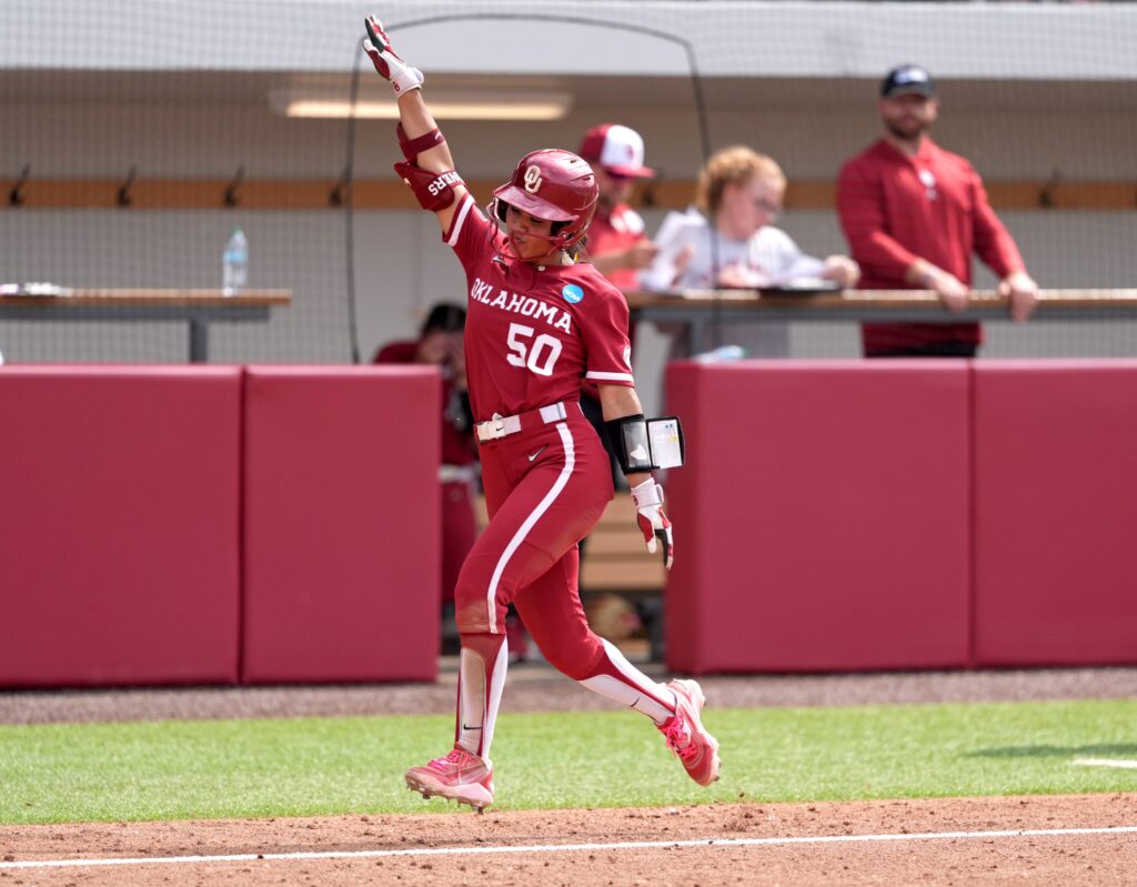 Oklahoma's Ailana Agbayani (50) hits a homer run in the 7th inning during the NCAA Norman Softball Regional game between the University of Oklahoma Sooners and Michigan Wolverines at Love's Field in Norman, Okla