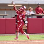 Oklahoma's Ailana Agbayani (50) hits a homer run in the 7th inning during the NCAA Norman Softball Regional game between the University of Oklahoma Sooners and Michigan Wolverines at Love's Field in Norman, Okla