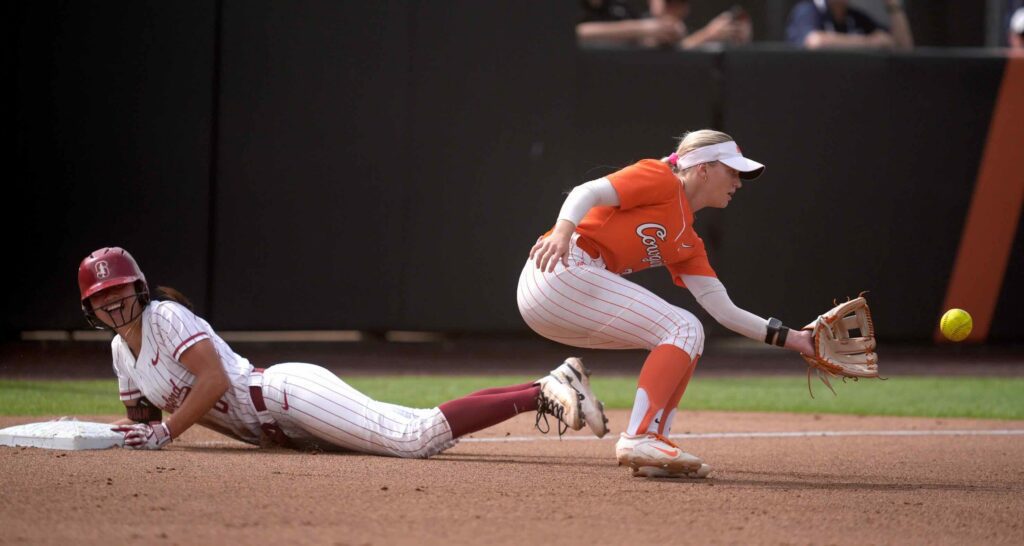 NCAA softball viewership star Stanford Cardinal outfielder Kyra Chan (8) slides to third as Oklahoma State Cowgirls infielder Rosie Davis (26) waits on the ball in the fourth inning ion the NCAA softball tournament Stillwater Regional final between the Oklahoma State University Cowgirls and the Stanford Cardinal on ESPN.
