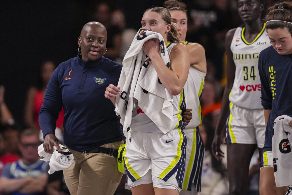 Dallas Wings guard Paige Bueckers (5) is assisted after falling and being injured against the Atlanta Dream.
