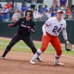 Florida infielder Madison Walker (24) looks for the throw while Texas Tech second baseman Mia Williams (1) contemplates a steal during game 3 of the super regional of the NCAA Division 1 softball championship.