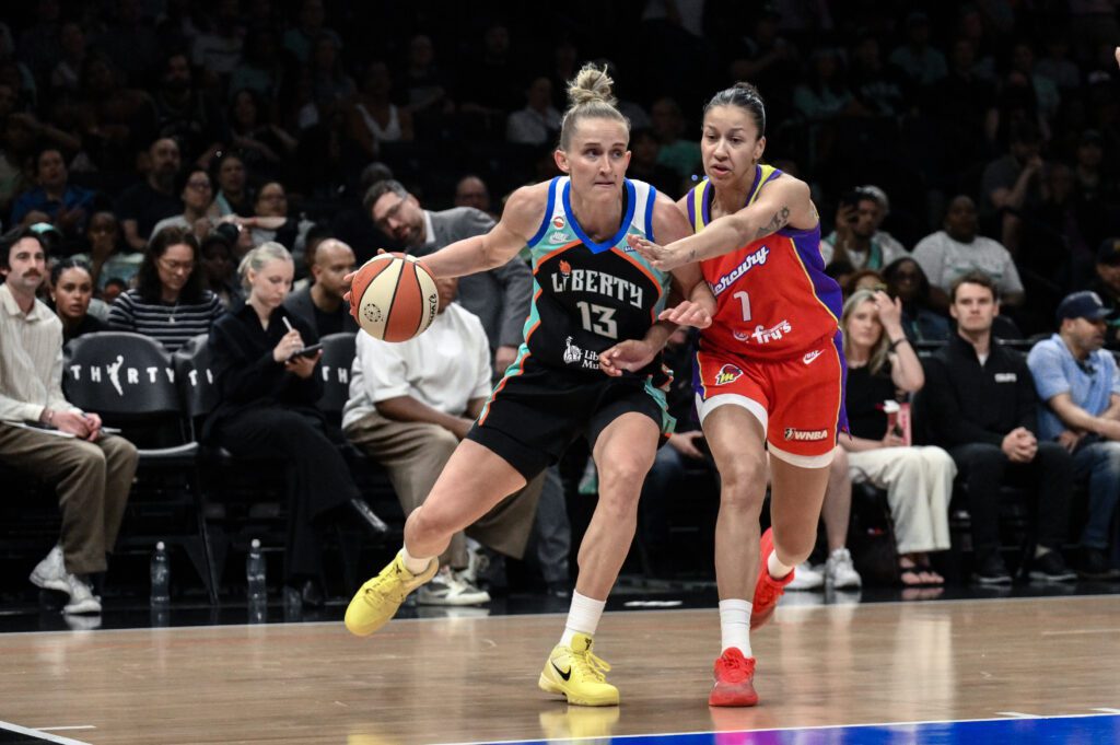New York Liberty forward Leonie Fiebich (13) tries to drive past Phoenix Mercury forward Noemie Brochant (1) during the first half at Barclays Center.