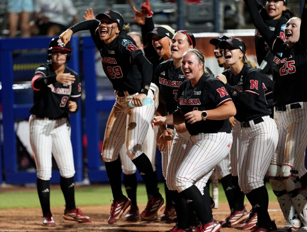 Nebraska celebrates the home run of Hannah Coor (23) in the eighth inning during a Women's College World Series softball game between the Arkansas Razorbacks and the Nebraska Cornhuskers at Devon Park in Oklahoma City.