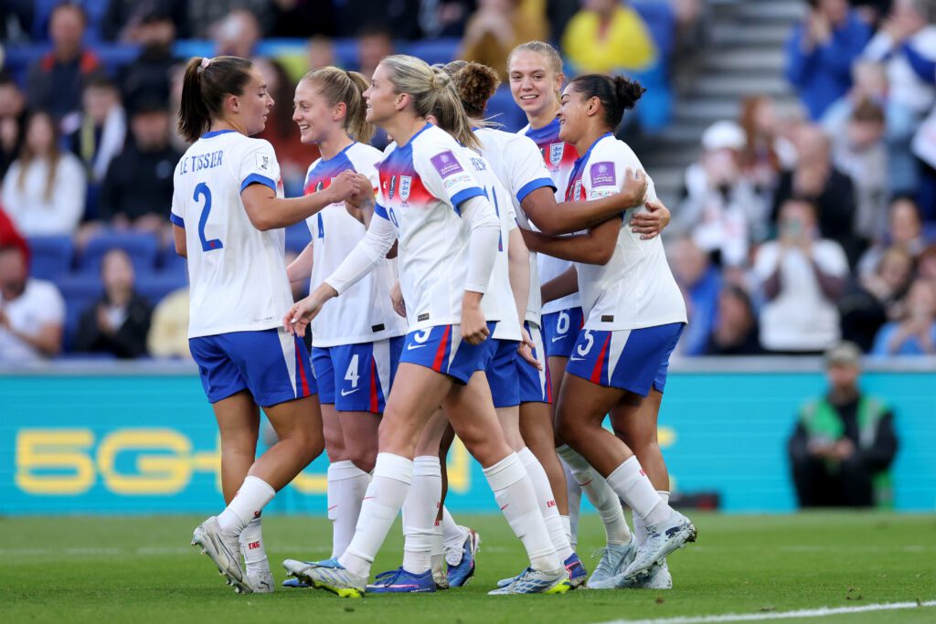 Jess Carter of England celebrates scoring her team's first goal with teammates during the FIFA Women's World Cup 2027 Qualifier match between England and Ukraine.