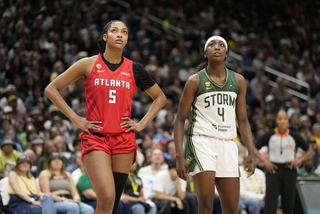 Flau'jae Johnson #4 of the Seattle Storm and Angel Reese #5 of the Atlanta Dream look on during the game on June 27, 2026 at Climate Pledge Arena.