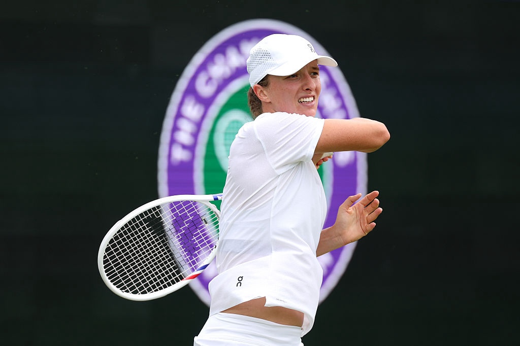 Iga Swiatek of Poland plays a forehand during a training session before The Championships Wimbledon 2026 at All England Lawn Tennis and Croquet Club on June 27, 2026 in London, England ahead of a potential third-round match with Serena Williams.