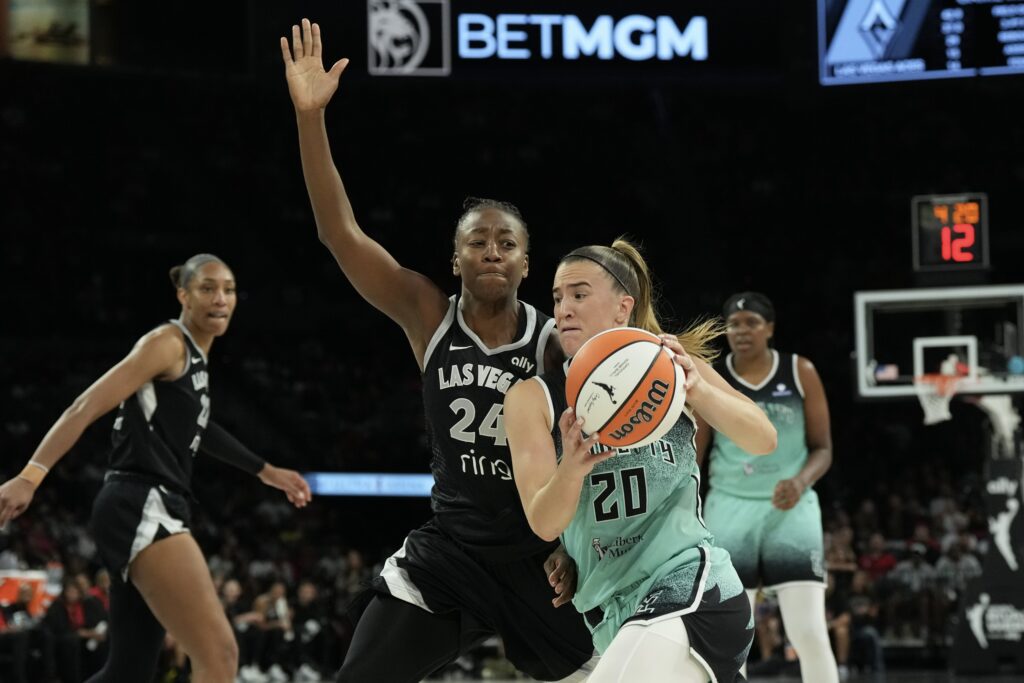 New York Liberty guard Sabrina Ionescu (20) drives against Las Vegas Aces guard Jewell Loyd (24) during the fourth quarter of their game at Michelob Ultra Arena.