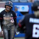 Texas Tech's Mihyia Davis (42) celebrates a score in the sixth inning of a Women's College World Series softball game between Texas Tech Red Raiders and the UCLA Bruins at Devon Park in Oklahoma City, May 31, 2026.