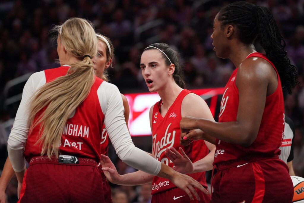 Indiana Fever guard Caitlin Clark (22) talks with guard Sophie Cunningham (8), guard Lexie Hull (10), and Indiana Fever during a game against the Golden State Valkyries in the fourth quarter at Chase Center ahead of the Fever vs Dream WNBA game.