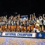 Texas Longhorns players and coaches pose for a group photo after defeating the Texas Tech Red Raiders to win the NCAA Women’s College World Series championship series at Devon Park.