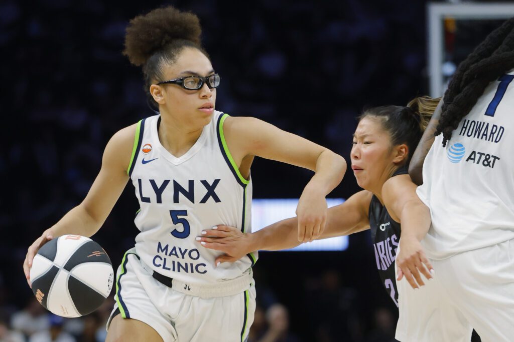 Minnesota Lynx guard Olivia Miles (5) drives with the ball against Golden State Valkyries guard Kaitlyn Chen (2) in the third quarter at Target Center.