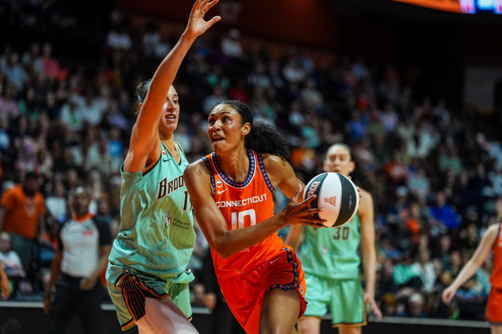 Connecticut Sun center Olivia Nelson-Ododa (10) drives the ball against New York Liberty forward Raquel Carrera (14) in the second half at Mohegan Sun Arena.