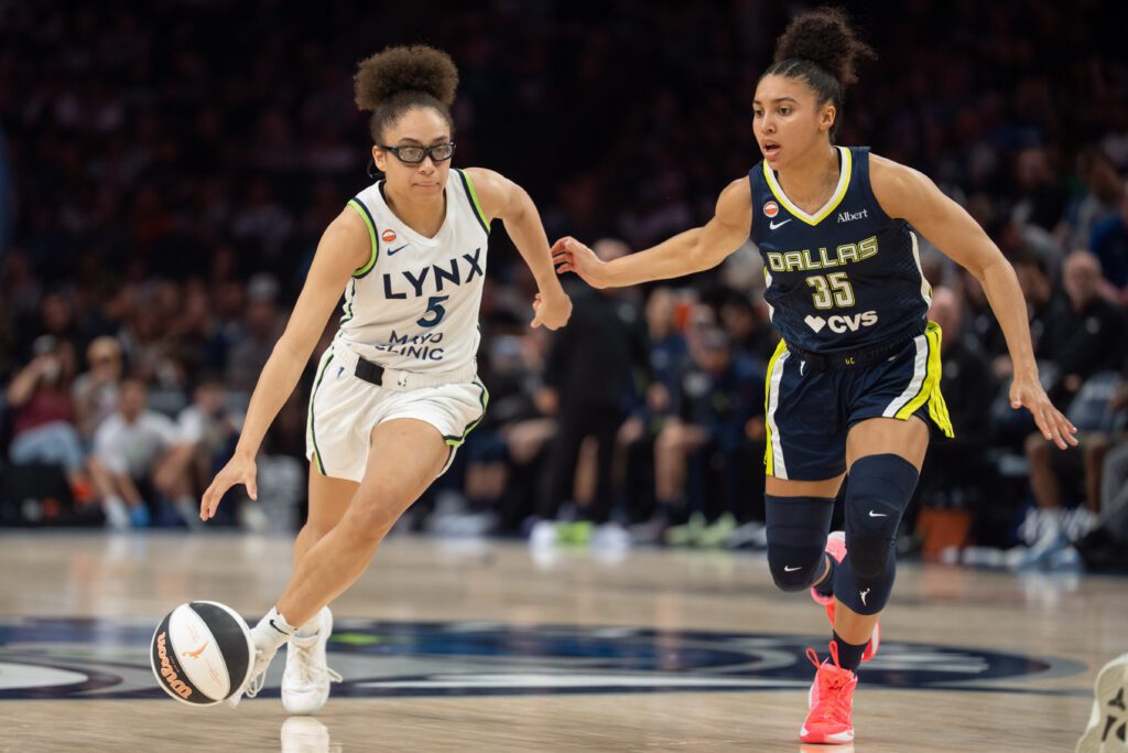 Minnesota Lynx guard Olivia Miles (5) drives by the defense of Dallas Wings guard Azzi Fudd (35) in the third quarter at Target Center.