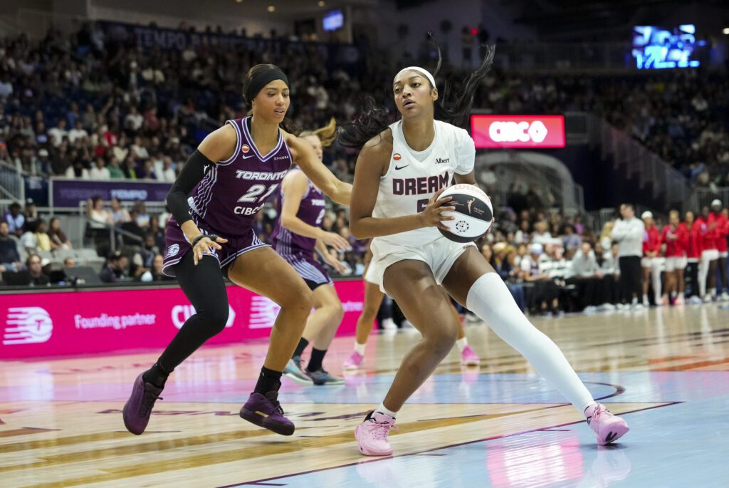 Atlanta Dream forward Angel Reese (5) dribbles against Toronto Tempo forward Isabelle Harrison (21) during the first half at Coca-Cola Coliseum.