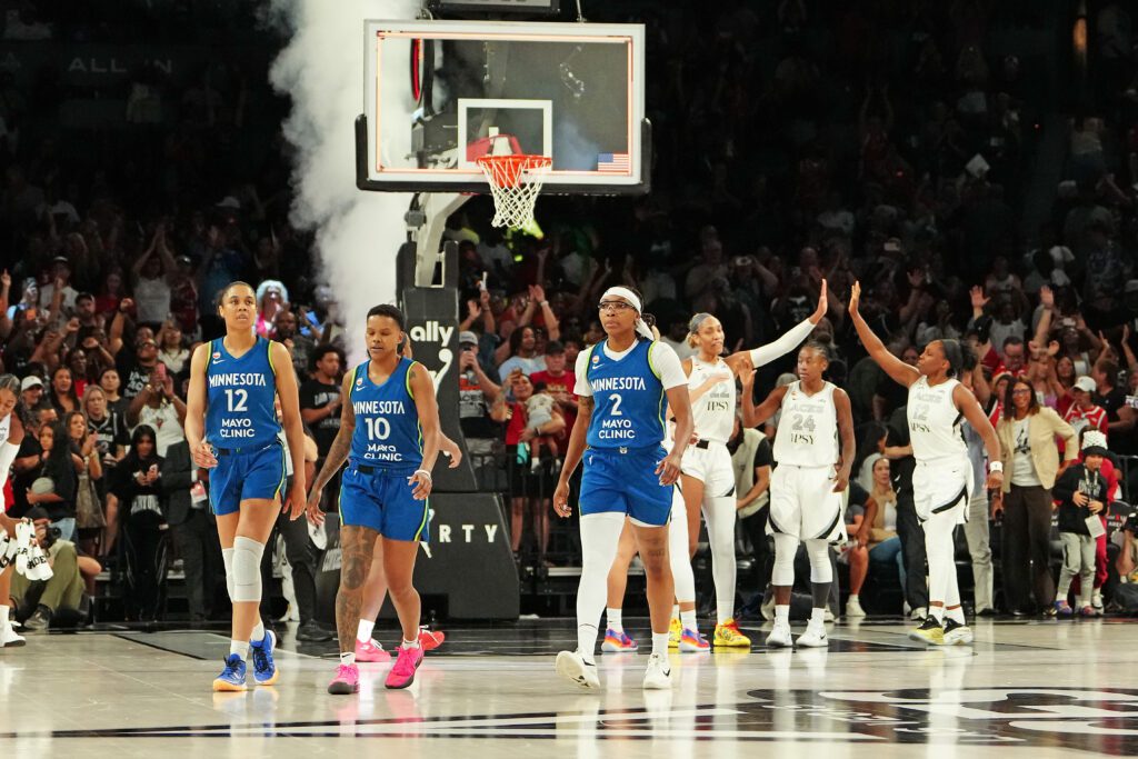 Minnesota Lynx forward Nia Coffey (12), guard Courtney Williams (10), and forward Liatu King (2) walk off the floor after being defeated by the Las Vegas Aces 100-97 at Michelob Ultra Arena.