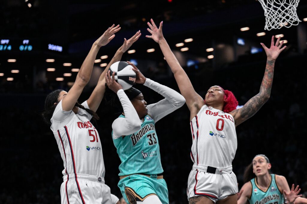 New York Liberty center Jonquel Jones (35) tries to get past Washington Mystics center Lauren Betts (51) and center Shakira Austin (0) during the first half at Barclays Center.