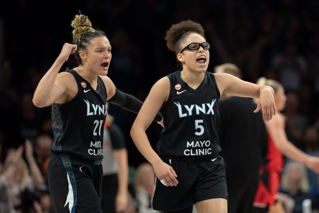 Minnesota Lynx guard Olivia Miles (5) celebrates with guard Kayla McBride (21) after making a shot against the Portland Fire in the second half at Target Center.