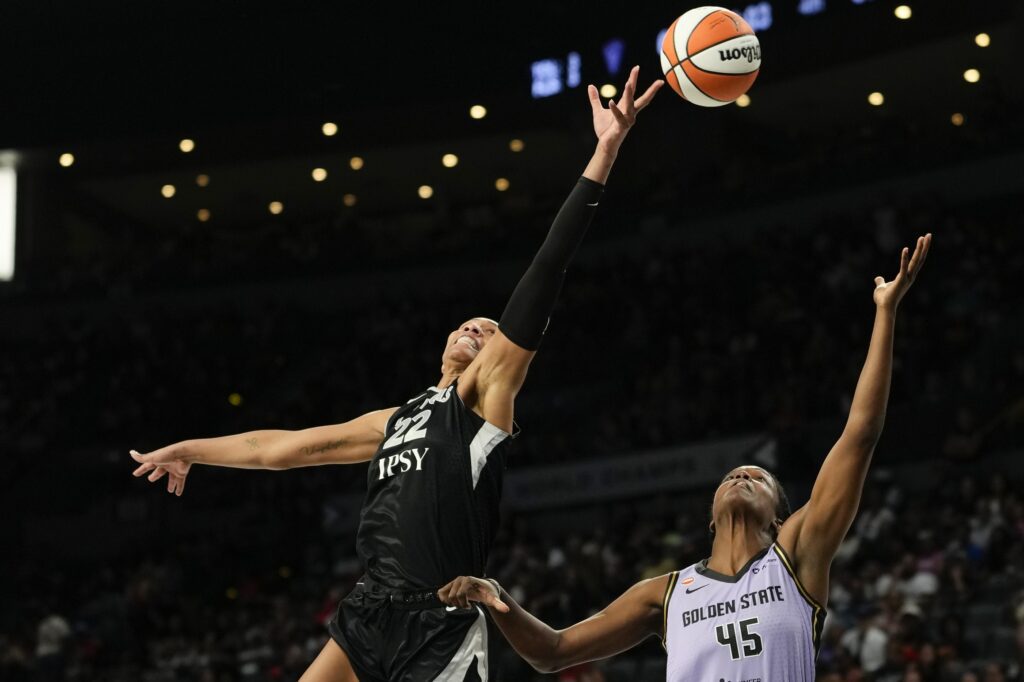 Las Vegas Aces center A'ja Wilson (22) reaches for the ball against Golden State Valkyries center Nadia Fingall (45) during the fourth quarter of a WNBA basketball game at Michelob Ultra Arena during the valkyries vs aces WNBA game.