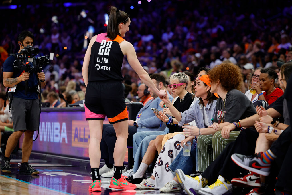 Caitlin Clark #22 of Team WNBA greets Aubrey Plaza during the second half of the 2024 WNBA All Star Game at Footprint Center on July 20, 2024 in Phoenix, Arizona.