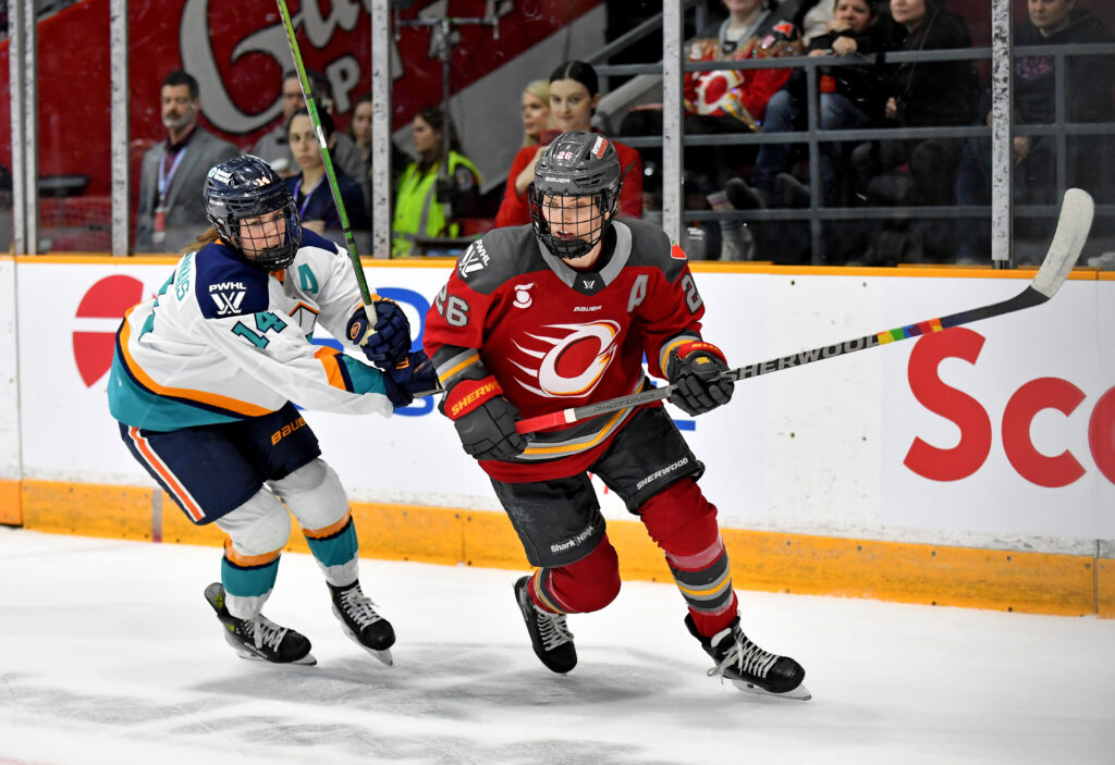 Emily Clark #26 of the Ottawa Charge skates against Jaime Bourbonnais #14 of the New York Sirens.