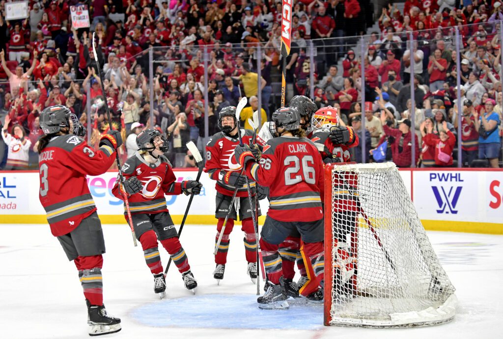 Peyton Hemp #29, Jocelyne Larocque #3, Emily Clark #26, Ronja Savolainen #88, and Gwyneth Philips #33 of the Ottawa Charge celebrate after the win against the Montreal Victoire in game 3 of the PWHL Walter Cup Final.