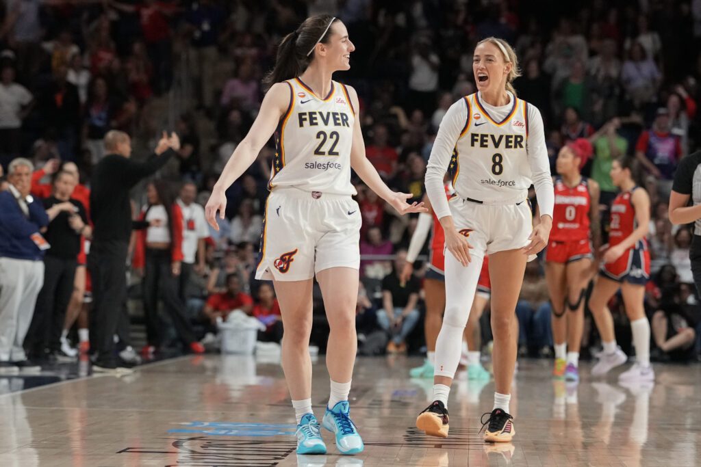 Caitlin Clark #22 of the Indiana Fever celebrates with Sophie Cunningham #8 after scoring the game-winning three pointer during the second half against the Washington Mystics.