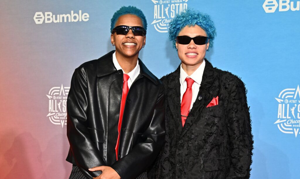 Natisha Hiedeman and Courtney Williams pose on the 2026 WNBA All Star orange carpet.