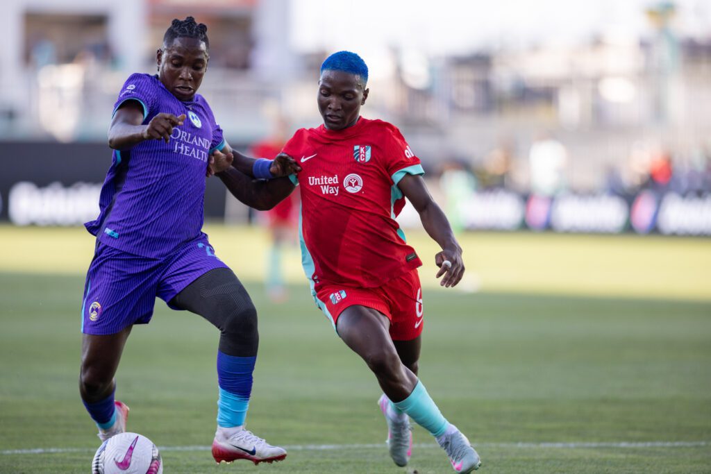 Orlando Pride forward Barbra Banda (22) and Kansas City Current forward Temwa Chawinga (6) compete for a ball during the first half of the match at CPKC Stadium.