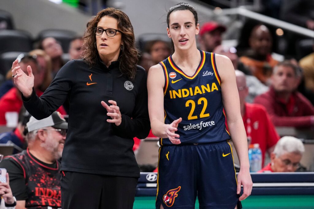 Indiana Fever head coach Stephanie White talks with Indiana Fever guard Caitlin Clark (22).