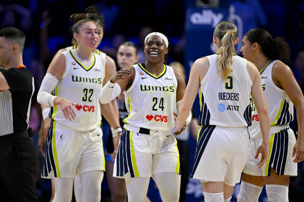 Dallas Wings guard Paige Bueckers (5) and forward Jessica Shepard (32) and guard Arike Ogunbowale (24) celebrates after Bueckers is fouled on a basket during the fourth quarter against the Chicago Sky.