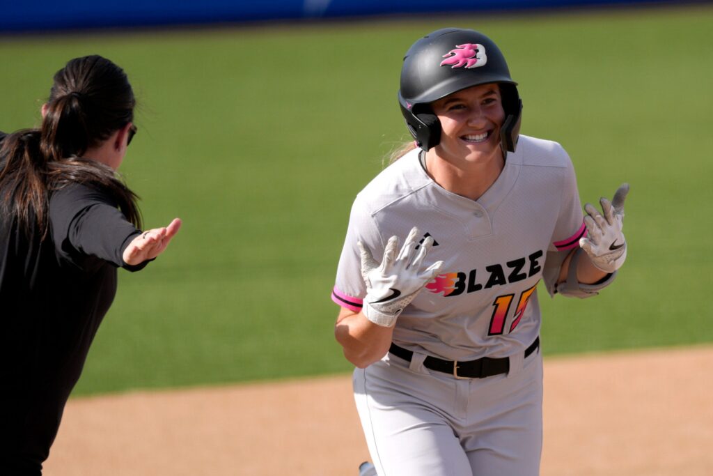 Reese Atwood of the Blaze celebrates after hitting a home run during an AUSL softball game between the Oklahoma City Spark and the Carolina Blaze at Oklahoma Christian University.