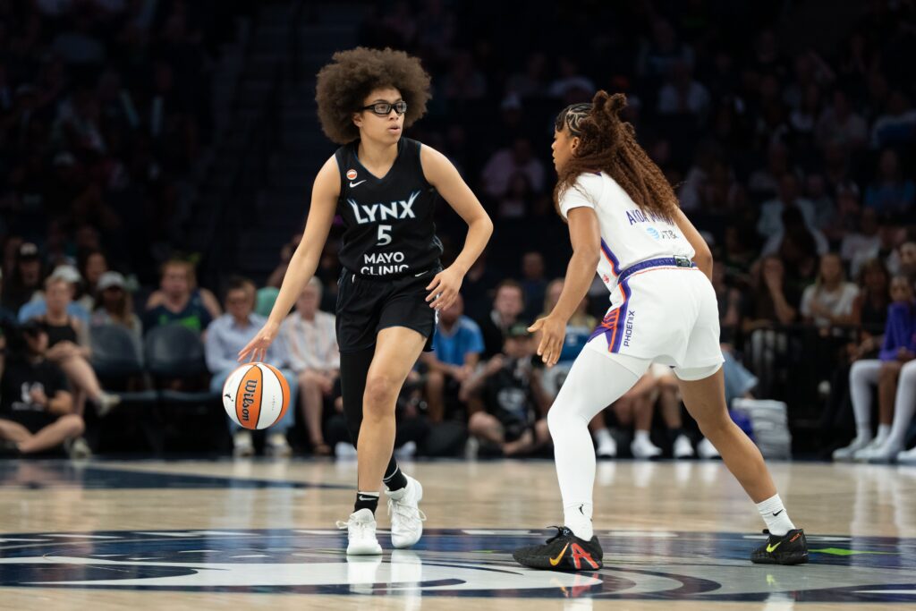 Jul 13, 2026; Minneapolis, Minnesota, USA; Minnesota Lynx guard Olivia Miles (5) dribbles the ball as Phoenix Mercury guard Monique Akoa Makani (8) plays defense in the first half at Target Center.