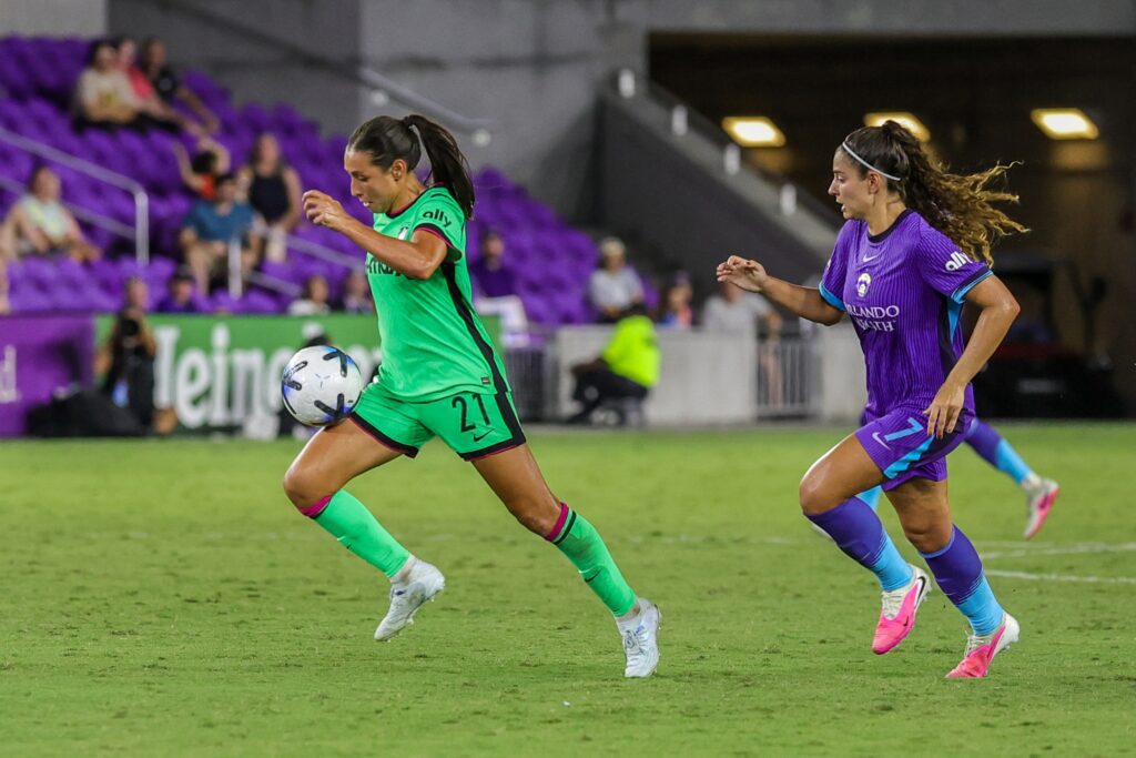 Boston Legacy FC midfielder Barbara Olivieri (21) moves the ball in front of Orlando Pride midfielder Angelina Alonso Costantino (7) during the second half at Inter&Co Stadium.