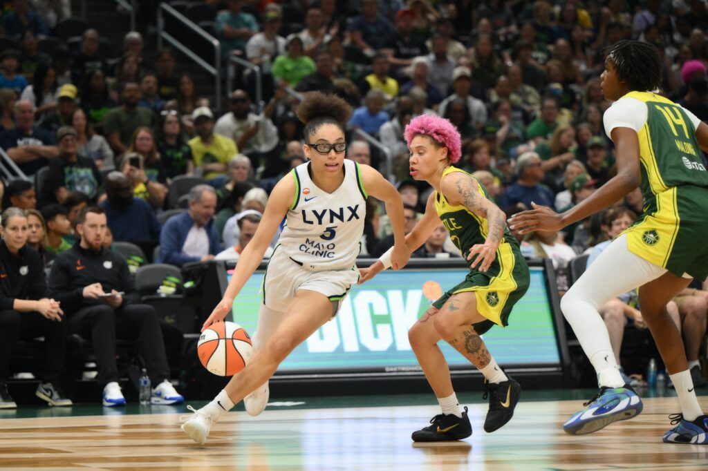 Minnesota Lynx guard Olivia Miles (5) dribbles the ball while guarded by Seattle Storm guard Natisha Hiedeman (2) during the first half at Climate Pledge Arena.