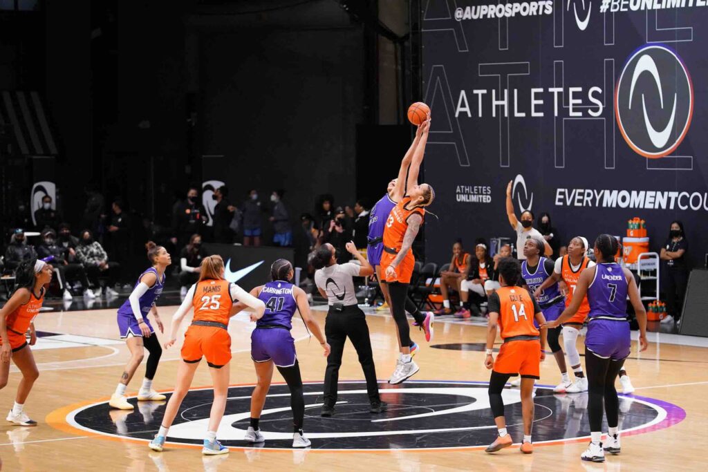 Team Russell center Mercedes Russell (13) and Team Carrington forward Isabelle Harrison (2) jump ball at the start of overtime at Athletes Unlimited Arena.