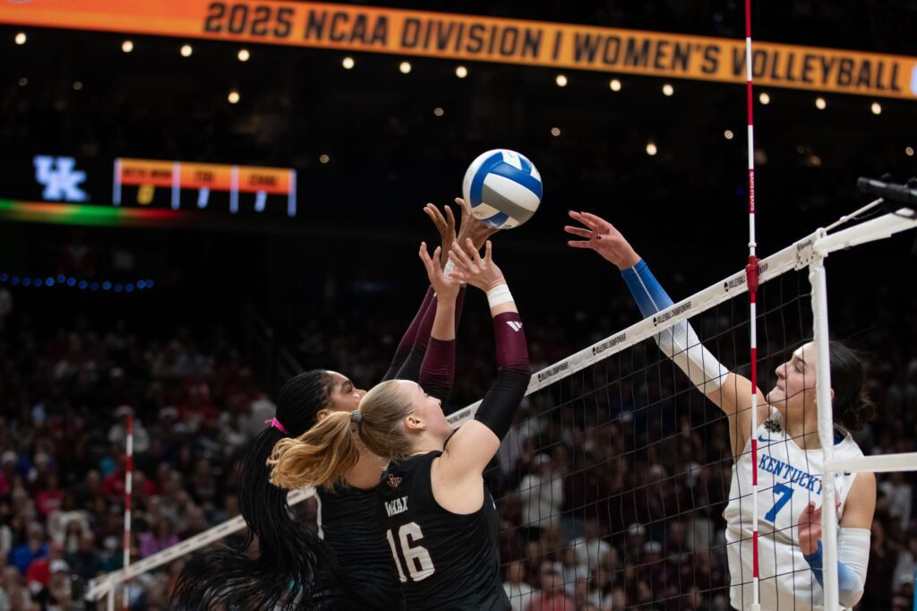Texas A&M Aggies middle blocker Ifenna Cos-Okpalla (1) and setter Maddie Waak (16) defend Kentucky Wildcats outside hitter Eva Hudson (7) in the second set of the 2025 NCAA WomenÕs Volleyball Championship at T-Mobile Center.