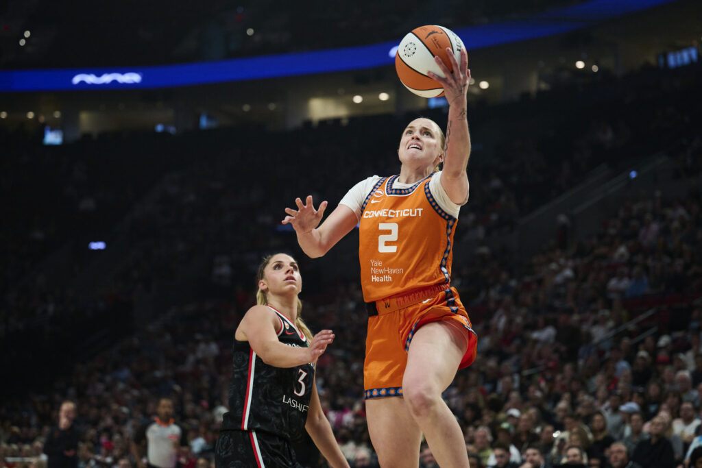 Connecticut Sun guard Hailey Van Lith (2) scores a basket during the first half against Portland Fire guard Sarah Ashlee Barker (3) at Moda Center.
