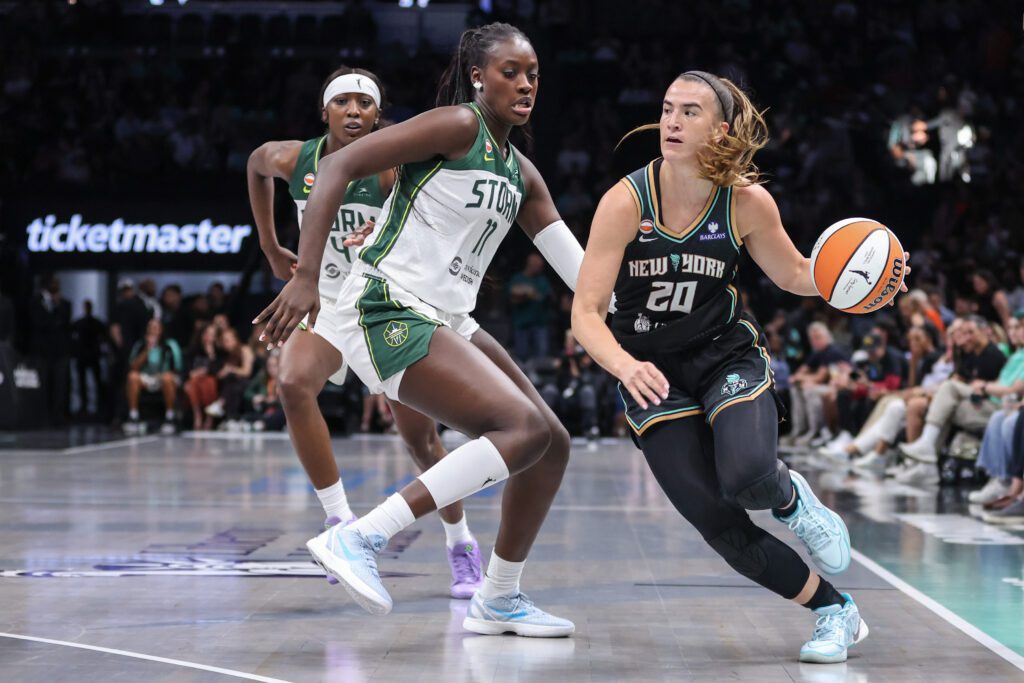 New York Liberty guard Sabrina Ionescu (20) drives past Seattle Storm center Awa Fam (11) in the first quarter at Barclays Center.