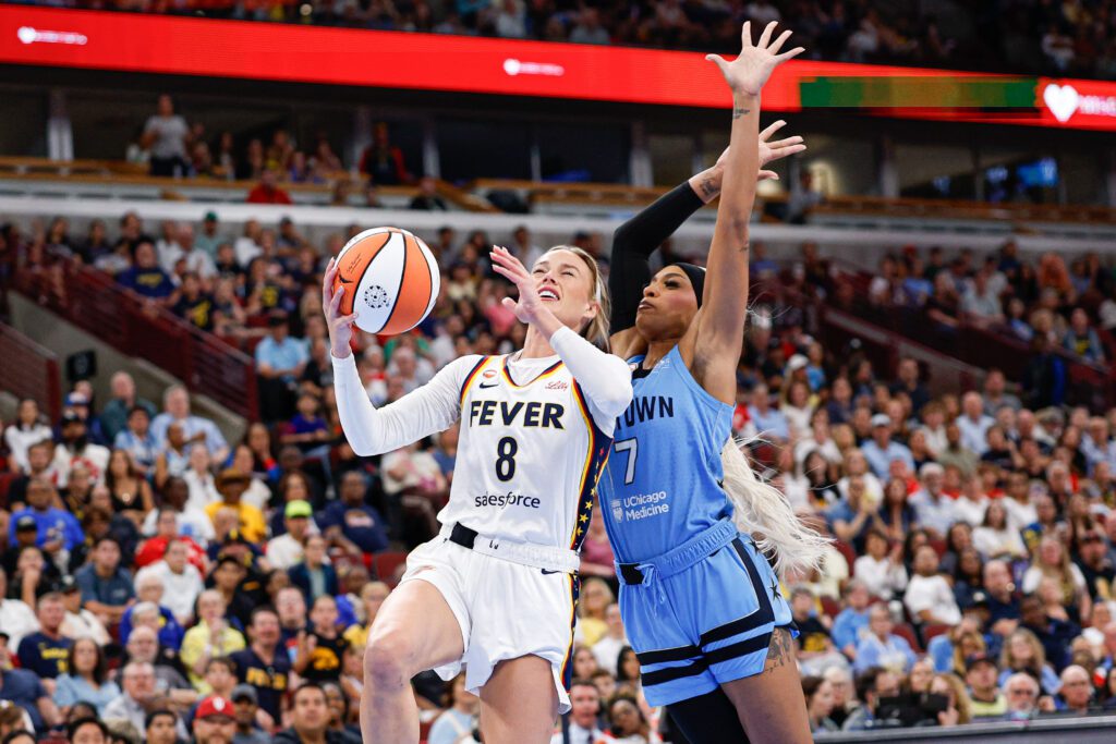 Indiana Fever guard Sophie Cunningham (8) drives to the basket against Chicago Sky guard DiJonai Carrington (7) during the first half at United Center.