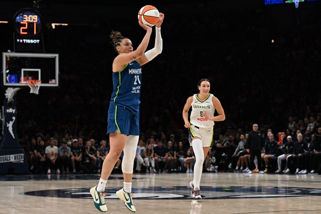 Minnesota Lynx guard Kayla McBride (21) shoots a three point basket as Dallas Wings forward Alanna Smith (8) looks on during the third quarter at Target Center.