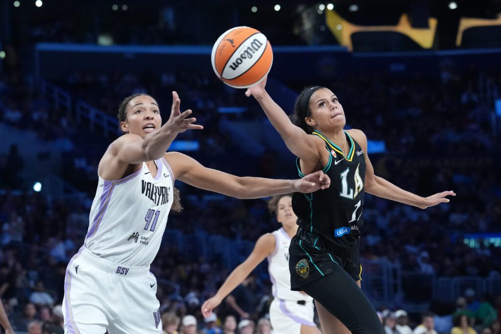 LA Sparks guard Rae Burrell (12) and Golden State Valkyries center Kiah Stokes (41) reach for the ball in the second half at Crypto.com Arena.